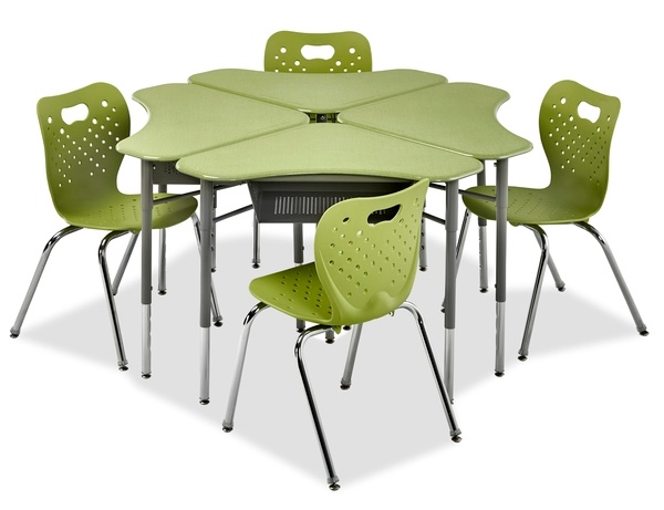 A boomerang shaped desk in a group of four with green plastic top and green chairs.