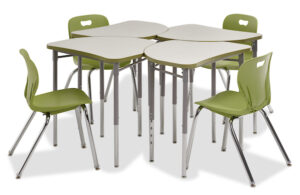 A mushroom top shaped desk with a 1/4 round curve in the top right corner. Arranged in a circular group of four, with green chairs on a white background.