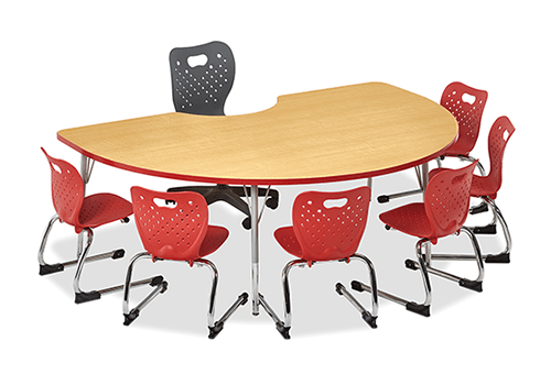 Kidney Shaped table with a laminate top six student chairs around the outside with one teacher chair in the middle.