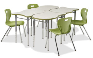 Scallop shaped desk in a group of four desks with chairs. Pictured on a white background