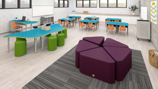 Classroom with soft seating and various shaped tables.